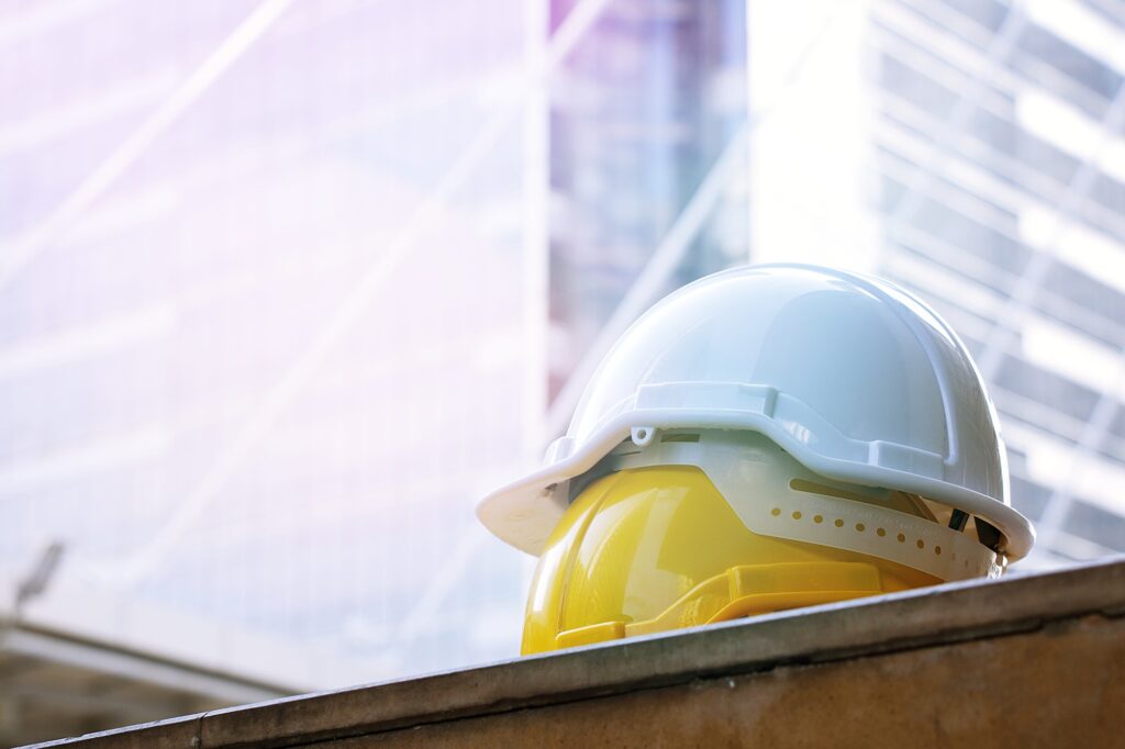 Safety hat on building background
